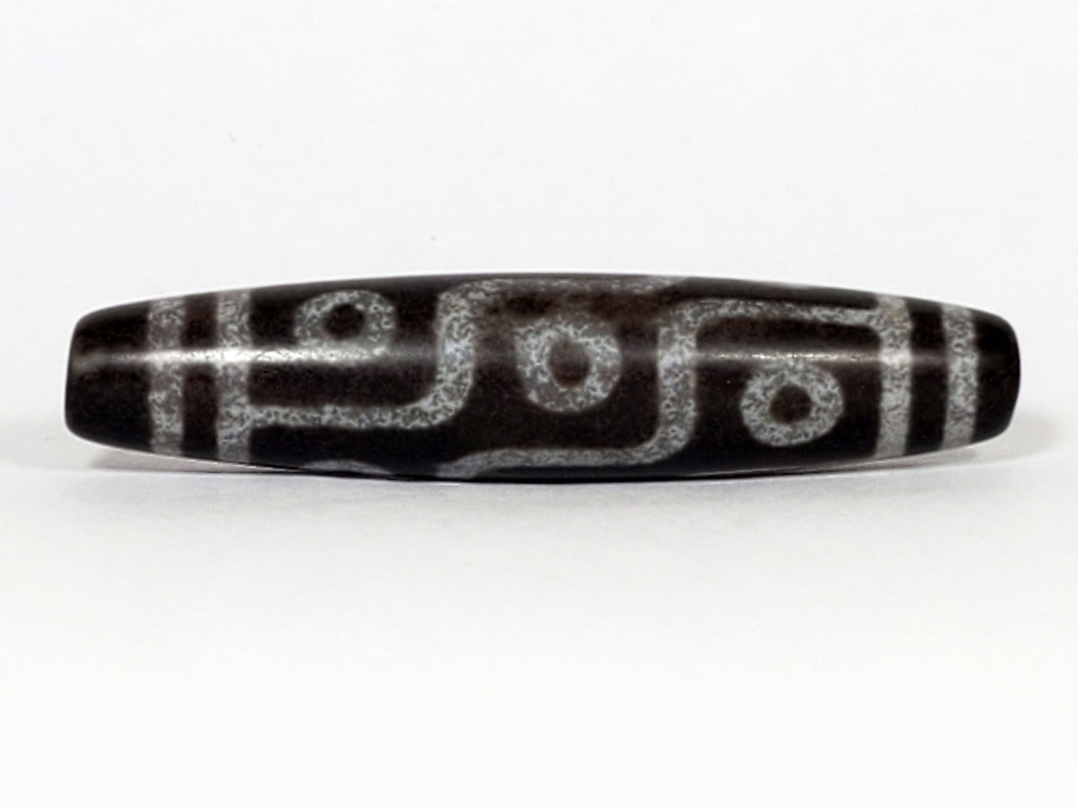 N-062226-9E3, face C, nine eye dzi, soft sandy-cream lines, warm brown agate, even symmetric fusiform, unretouched