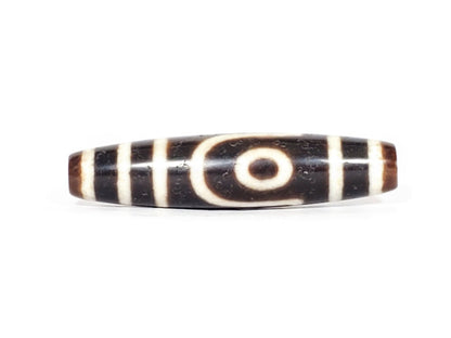 A vintage Dzi bead with a captivating Two Eye Motif. This authentic artifact exudes timeless charm and represents the intricate craftsmanship of ancient Dzi beads