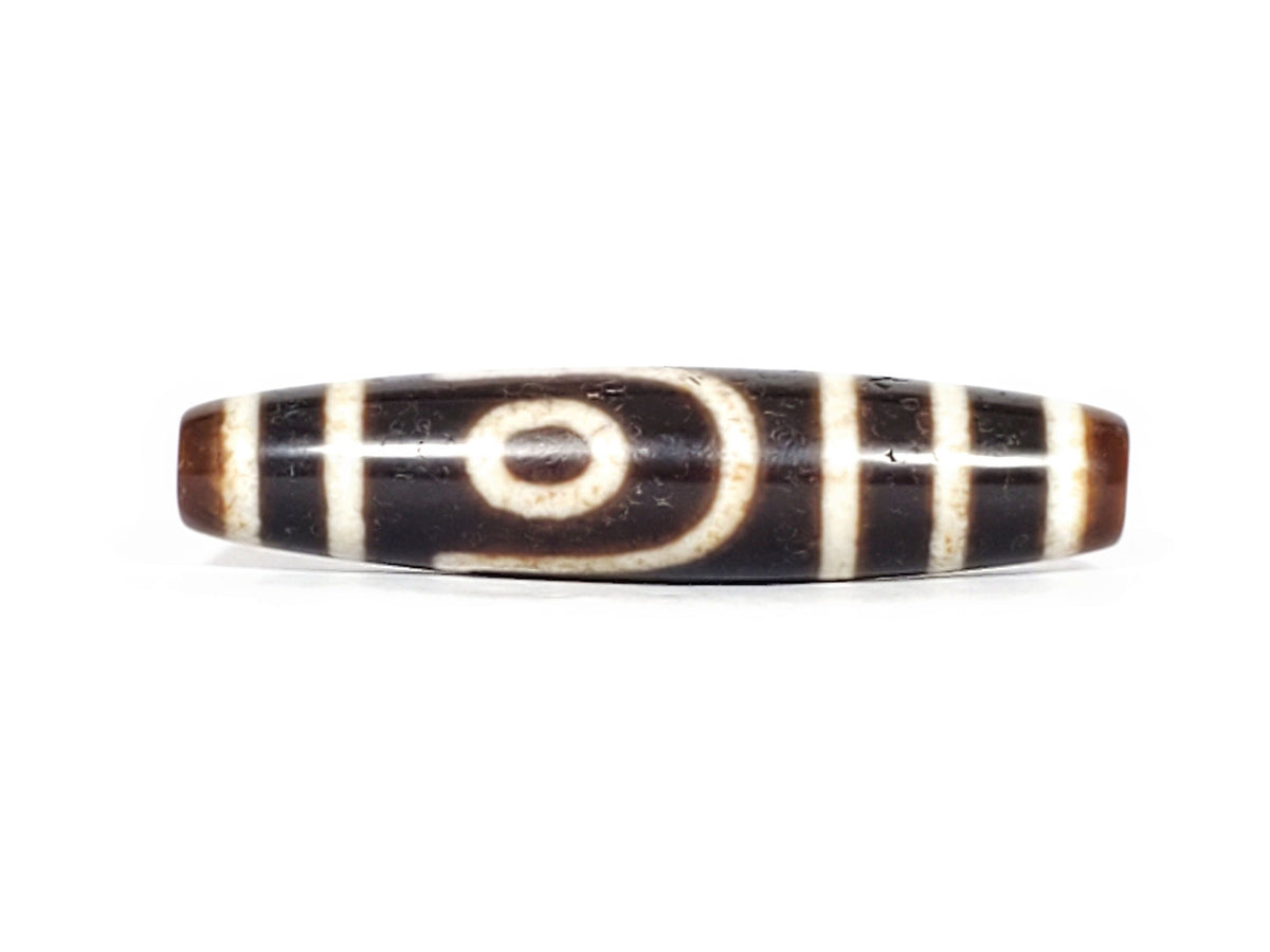V-070426-2E3 dzi bead, front view showing stepped-line face, brown-black agate, unretouched.