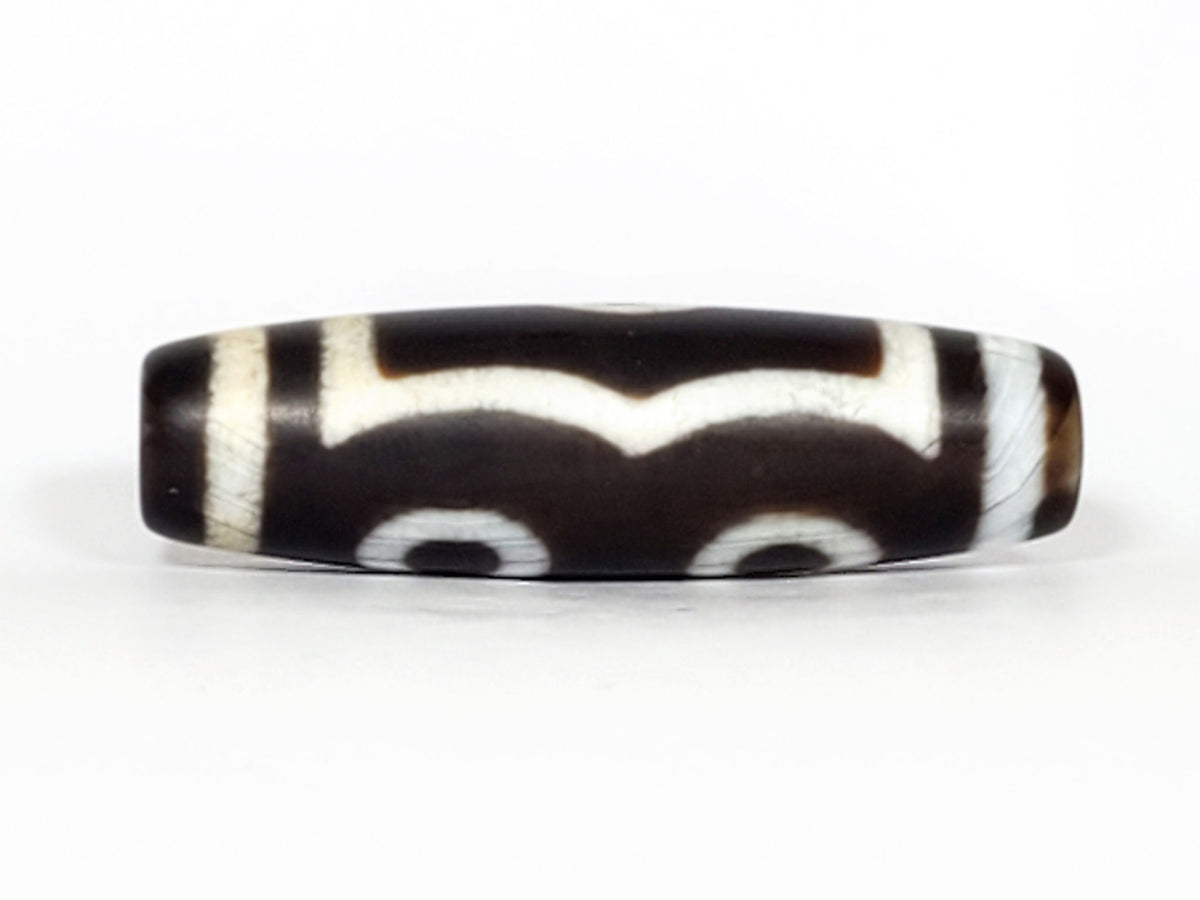 N-070226-3E dzi bead, angled view showing full stripe pattern, black agate, unretouched.
