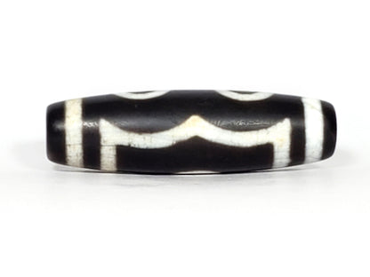 N-070226-3E dzi bead, diagonal view showing drill hole and single eye face, black agate, unretouched.