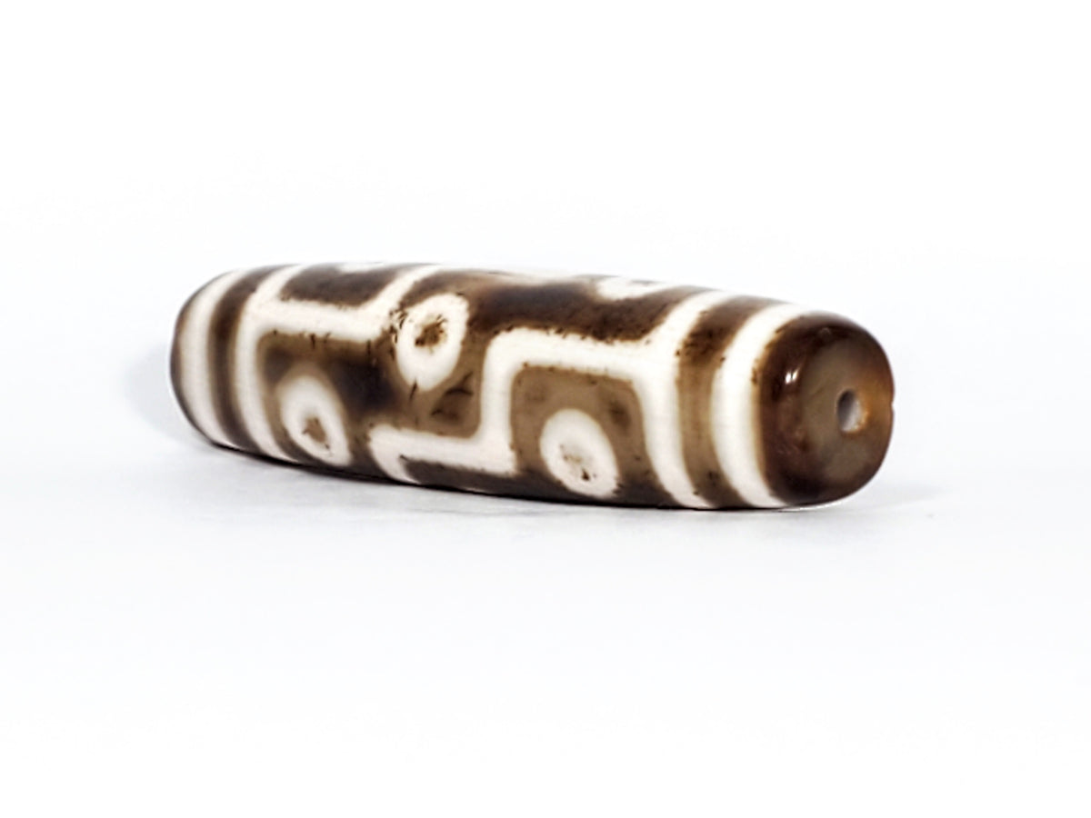 Antique Qing Dynasty nine-eye dzi bead, brown agate, white eye motifs, wave lines, visible drill hole, aged patina