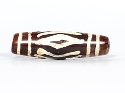 Antique carnelian dzi bead two diamond eye tiger tooth motif white etched pattern brown agate patina oval barrel shape
