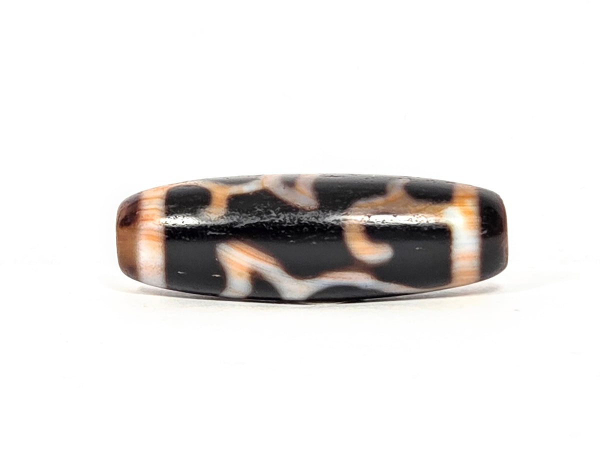 Vintage Lotus Bud Dzi Bead with bloodspot, natural agate patterning in black, white and brown tones, side view