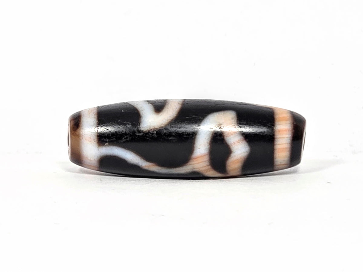 Vintage Lotus Bud Dzi bead with black agate and white bloodspot patterns, polished surface with drill hole