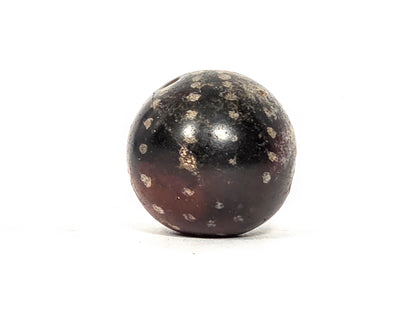 Second profile view of ancient round agate bead showing warm reddish-brown lower hemisphere, scattered star inclusion pattern, and smooth ancient surface, 22.3 mm × 21.5 mm