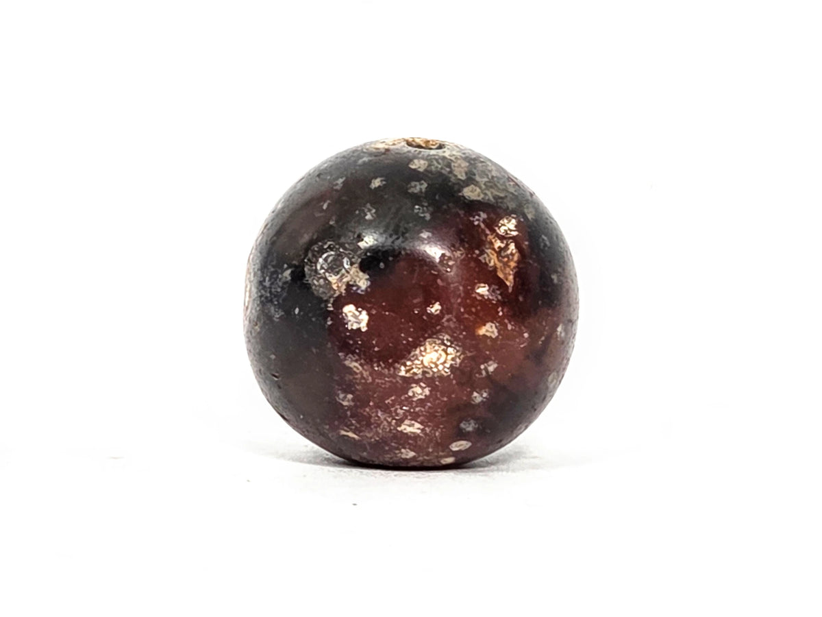 Fourth profile view of ancient round agate bead showing upper hemisphere with star inclusions and smooth polished surface on deep dark brown agate ground, 1500–2000 years old