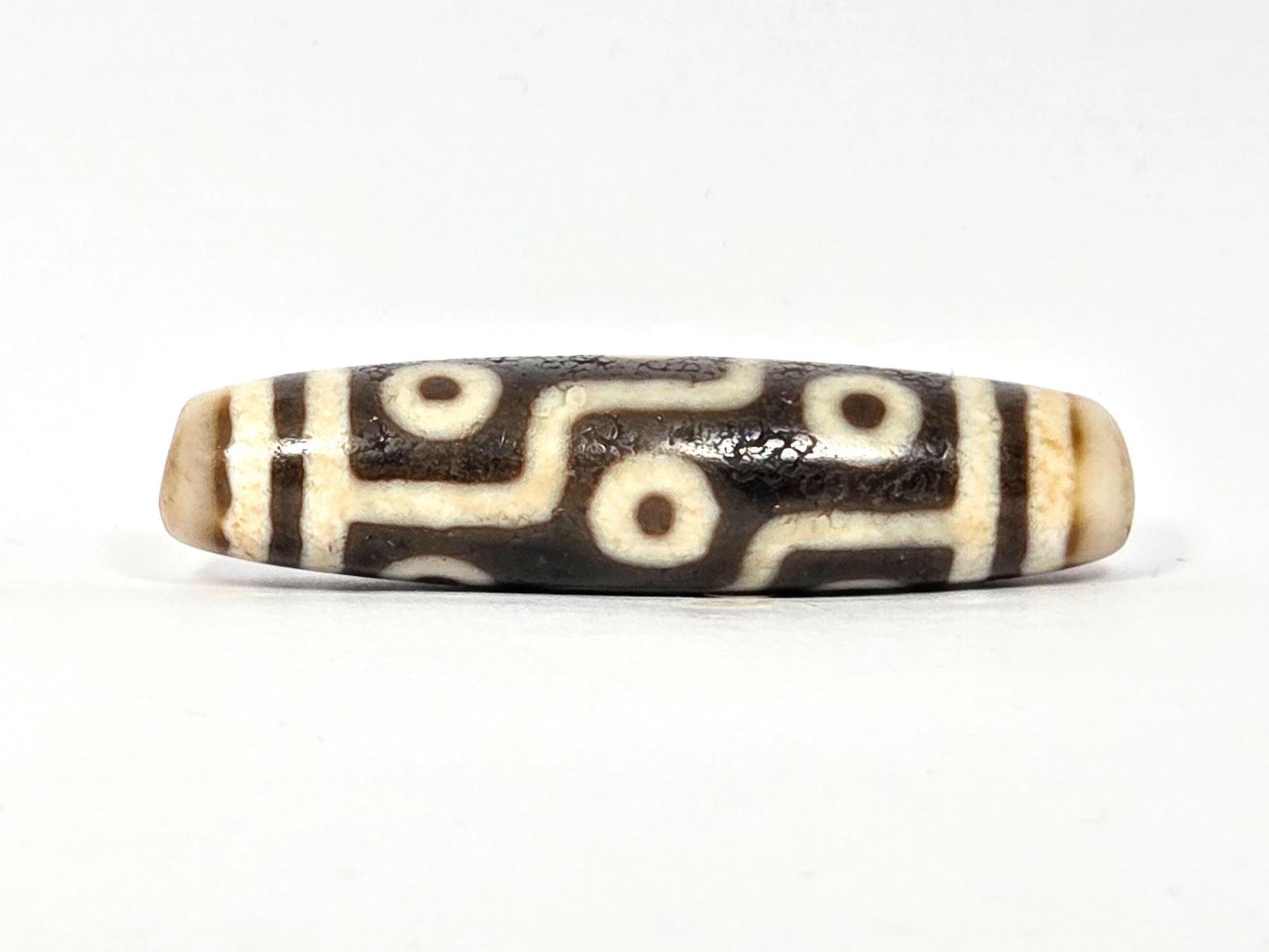 Rotated second face of ancient Nine Eye Dzi bead — nine eye circles on rare cream white agate, bold brown-black etching, 54mm, ~800 years old
