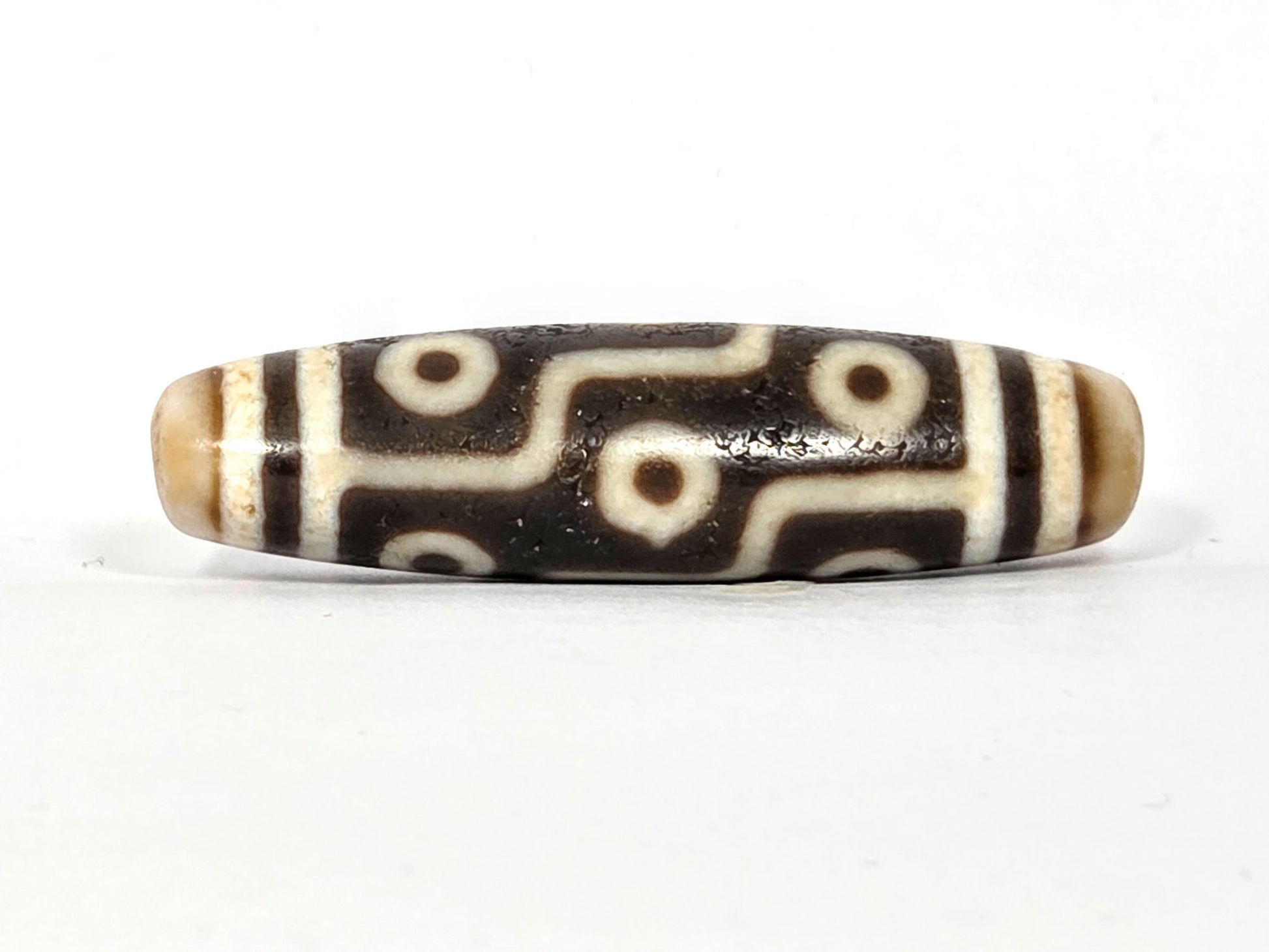 Third angle of ancient Nine Eye Tibetan Dzi bead — all nine eye circles visible across 54mm rare white agate body, genuine ancient Tibetan amulet