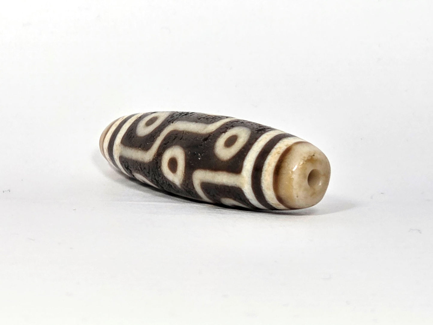 Fifth angle of ancient Nine Eye Dzi bead — warm ivory white agate with nine distinct eye circles, bold etching, 54mm genuine Tibetan amulet