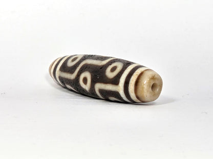 Fifth angle of ancient Nine Eye Dzi bead — warm ivory white agate with nine distinct eye circles, bold etching, 54mm genuine Tibetan amulet