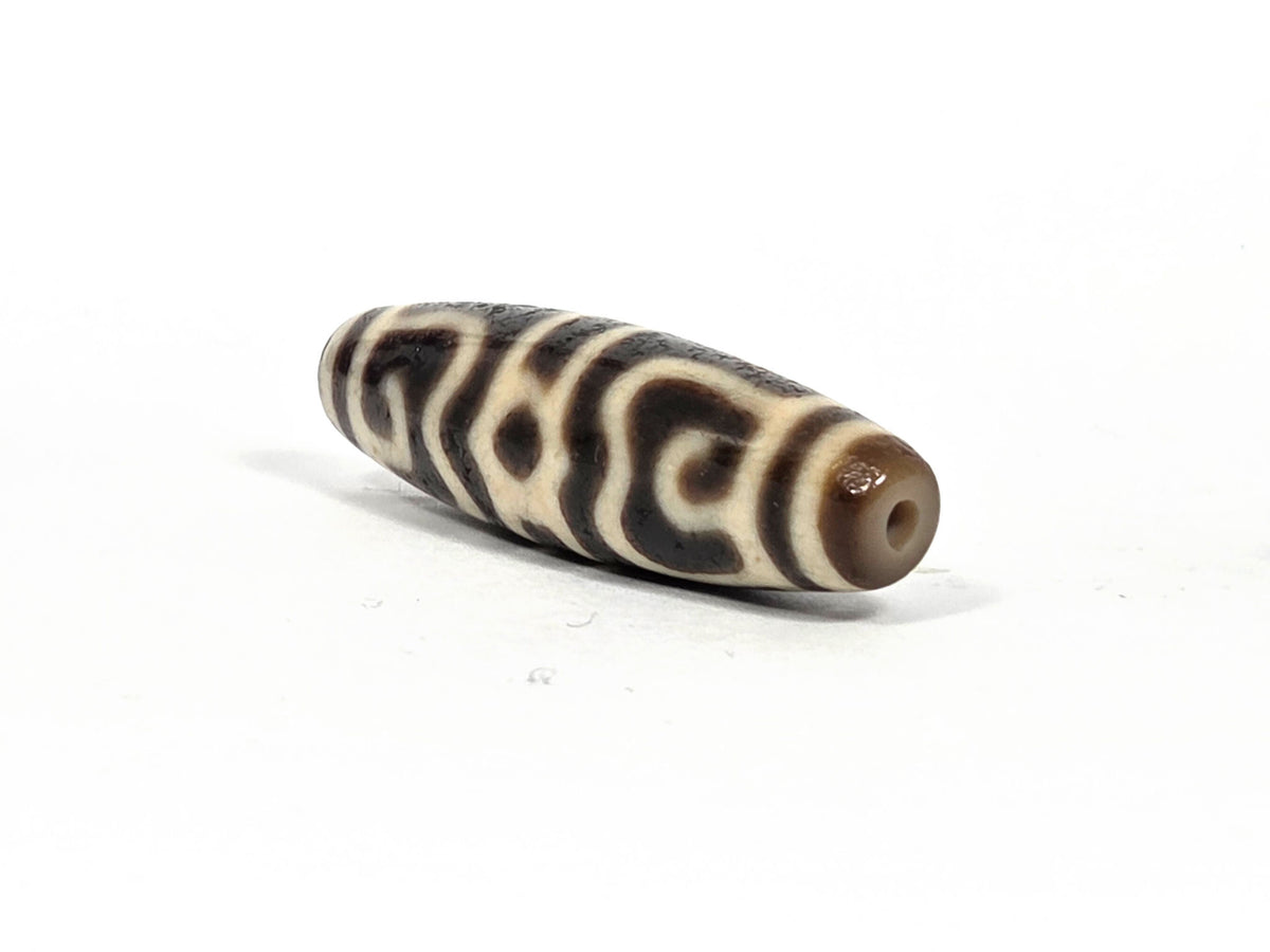 Ac-090626-GRDC3 ancient Guru Rinpoche Dharma Cap dzi angled drill end A warm brown end cap clean hole unretouched