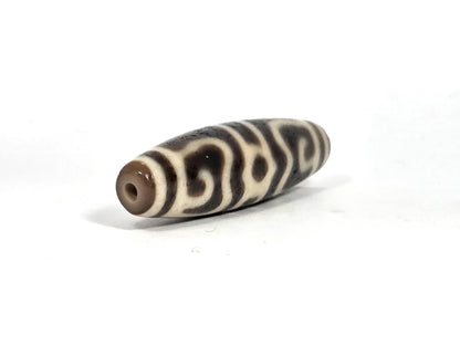 Ac-090626-GRDC3 ancient Guru Rinpoche Dharma Cap dzi angled drill end B warm brown end cap clean hole unretouched