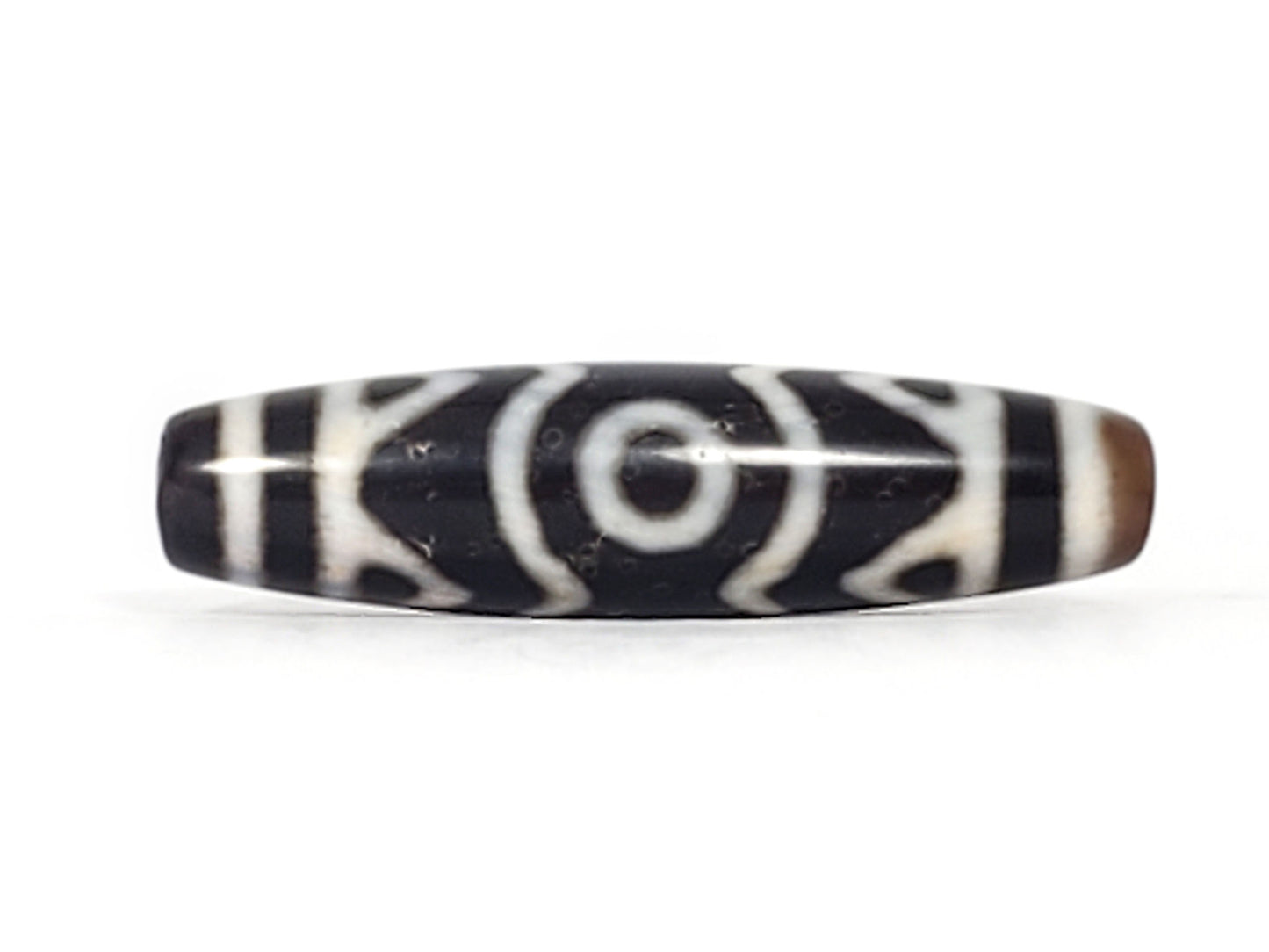 Rotated second face of ancient Three Eye Tiger Tooth Dzi bead — bold white eye circles on deep black agate, 48mm natural agate, 500+ years old