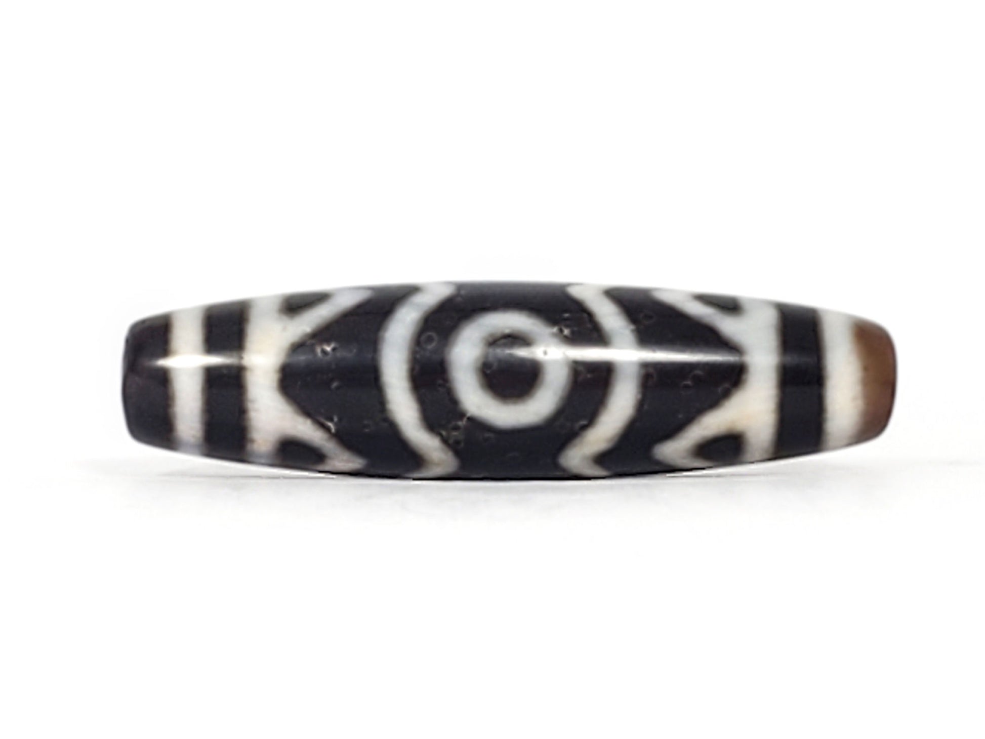 Rotated second face of ancient Three Eye Tiger Tooth Dzi bead — bold white eye circles on deep black agate, 48mm natural agate, 500+ years old