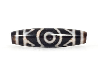 Third angle of ancient Three Eye Dzi bead — all three eye circles visible across 48mm length, tiger tooth etching alongside, unretouched
