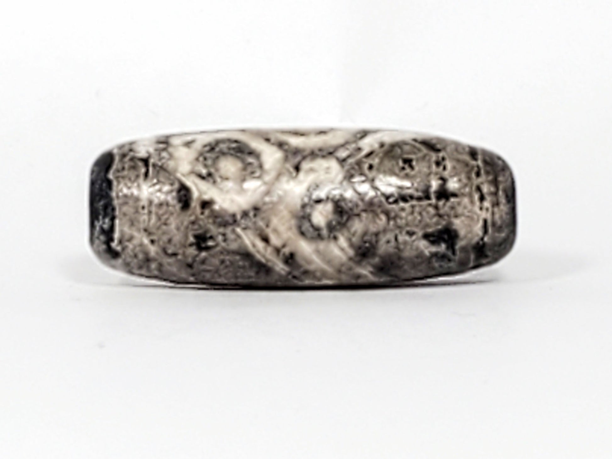 Second face of ancient Twelve Eye Lotus Dzi — cream calcification dominates, eye circles beneath