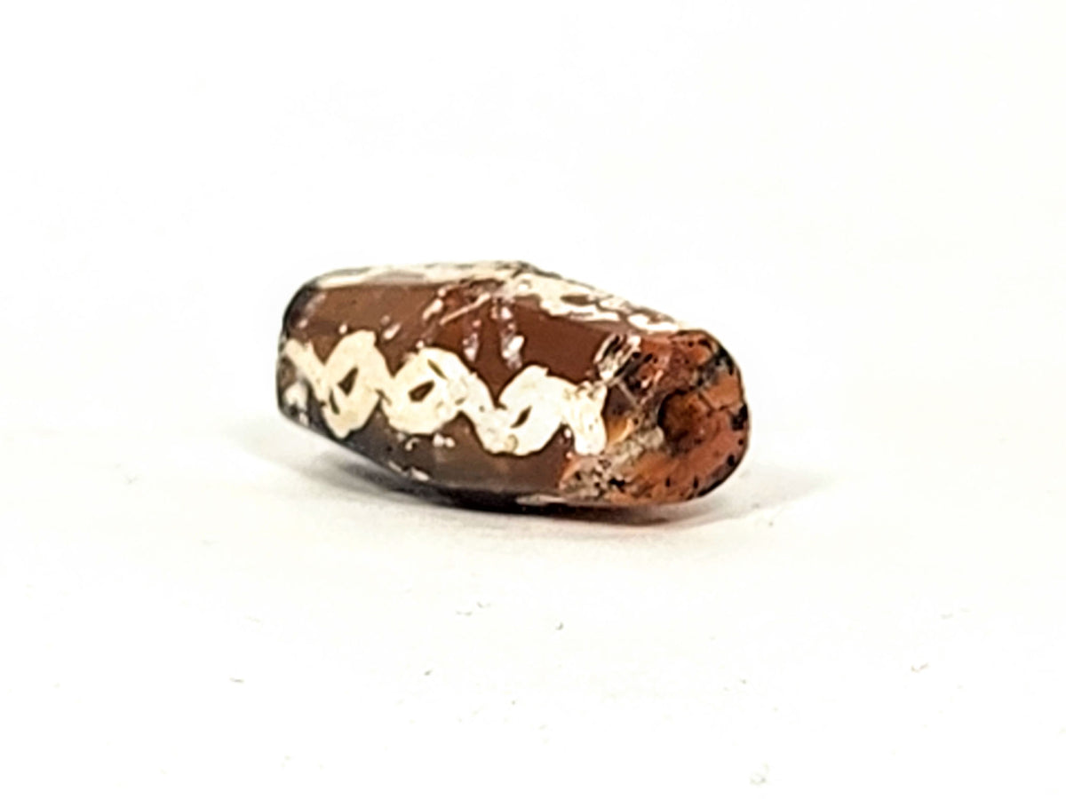 Ac-032425-LK opposite end, pronounced ancient bore weathering, orange-brown carnelian, chain links visible, unretouched