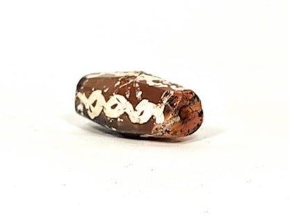 Ac-032425-LK opposite end, pronounced ancient bore weathering, orange-brown carnelian, chain links visible, unretouched
