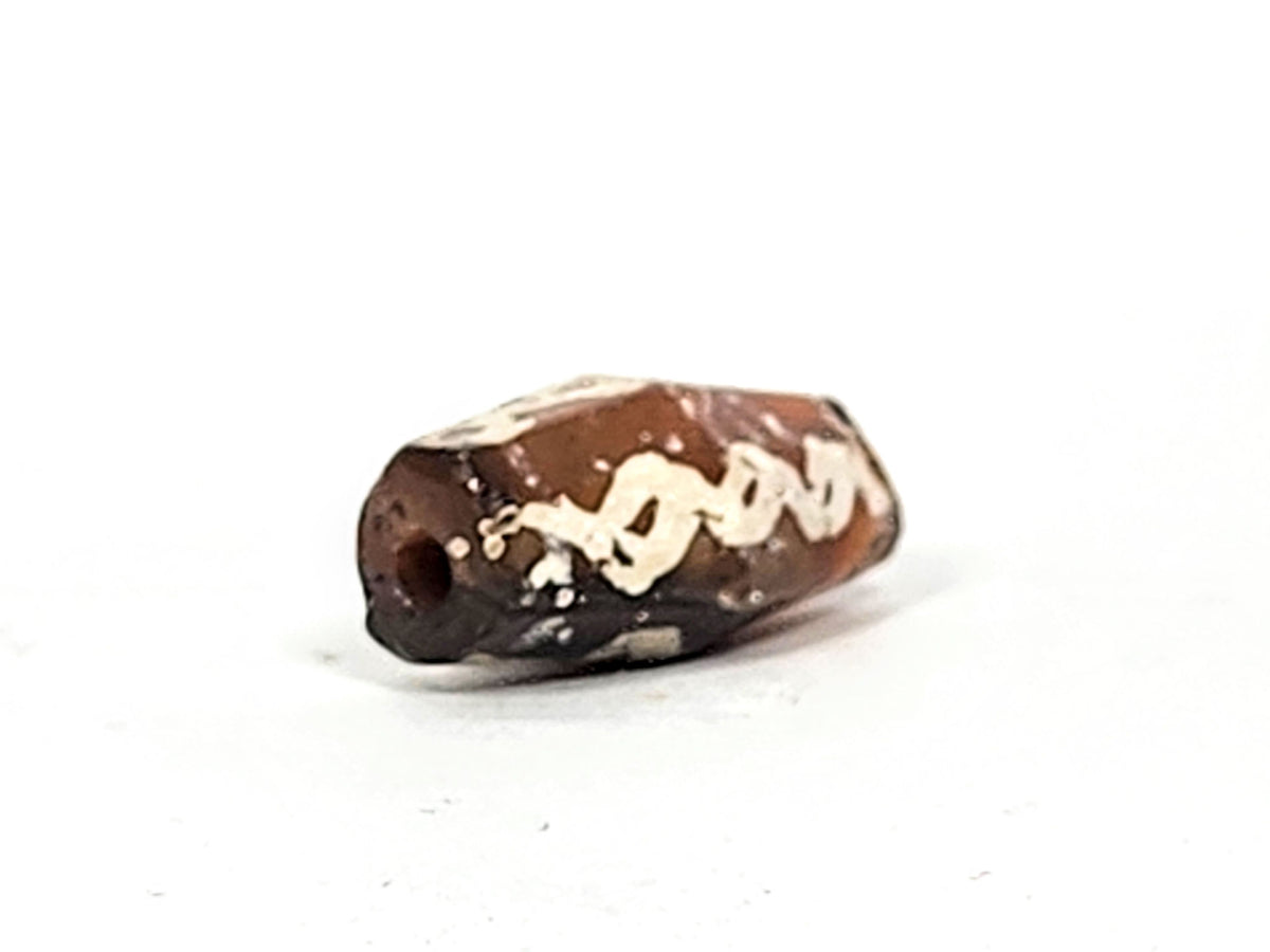 Ac-032425-LK angled end view, drill hole visible, warm orange-brown carnelian end cap, links band, unretouched