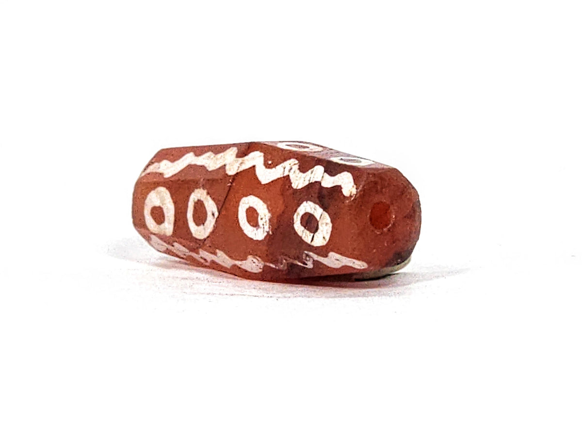 Ac-010825-16EW opposite end, drill hole, ring eyes on upper face, wave band, warm terracotta carnelian, unretouched