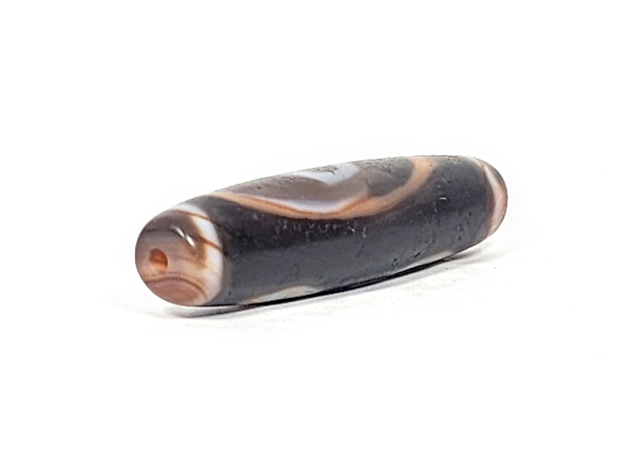 Ac-030525-3E right drill hole end, warm reddish-brown end cap and interior, pitch-black body, unretouched