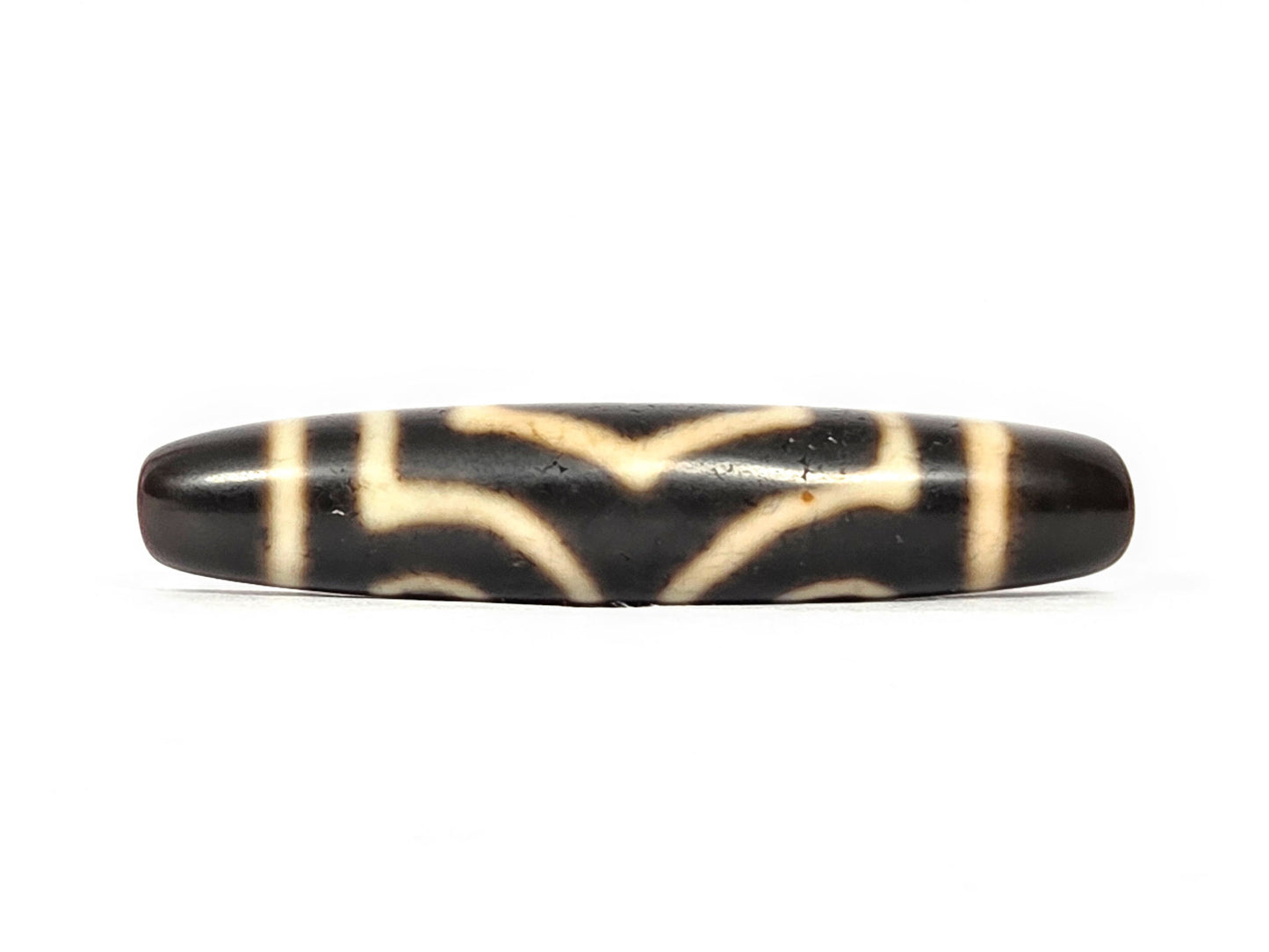 Side view of ancient Three Eye Dzi bead showing full-length profile and natural agate surface weathering — genuine Tibetan amulet