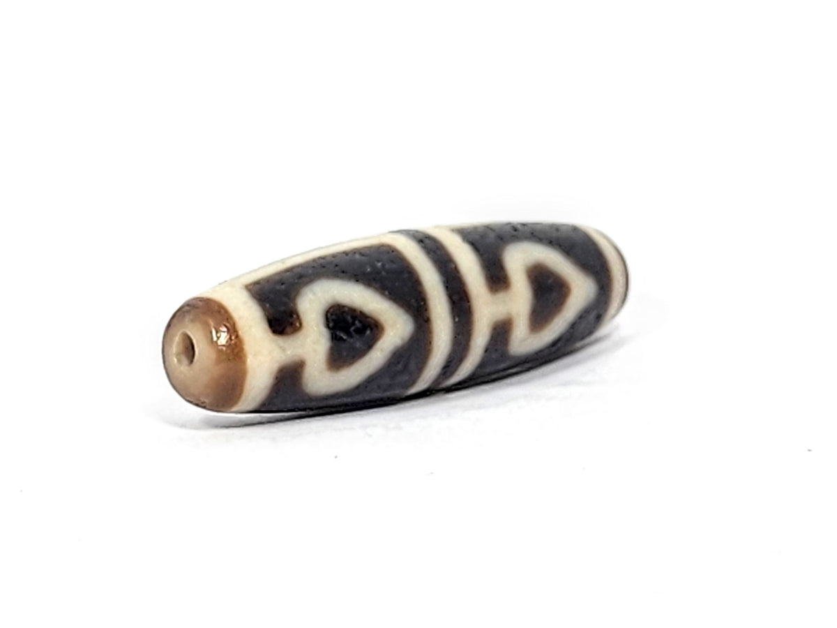 Ac-070625-FLB3 right drill hole end, warm honey-brown end cap, bodhi leaf forms wrapping pitch-black body, unretouched