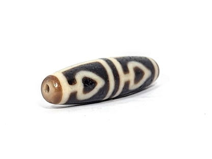 Ac-070625-FLB3 right drill hole end, warm honey-brown end cap, bodhi leaf forms wrapping pitch-black body, unretouched