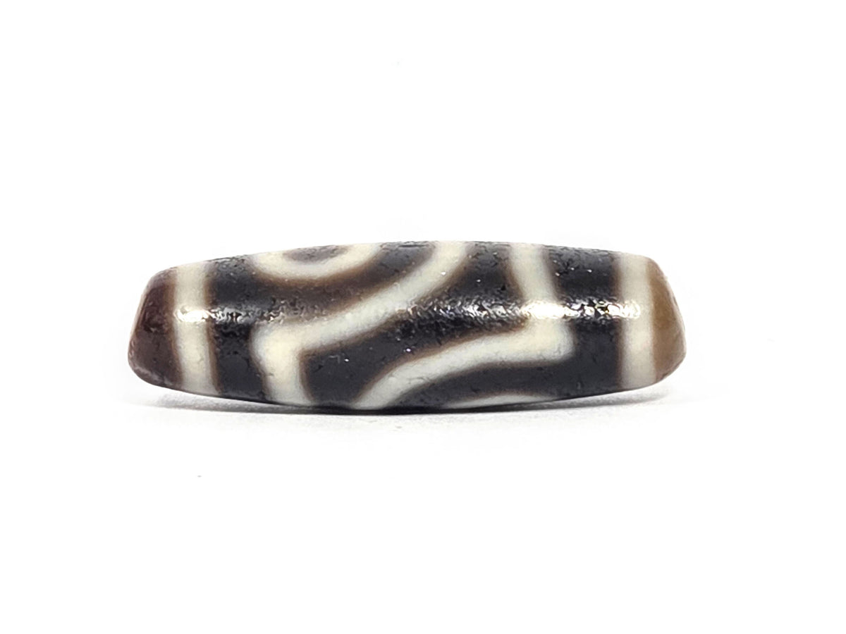 Ac-073026-2E ancient two eye dzi 35.8×11.8mm pitch-black agate angled view one eye stripe bands unretouched