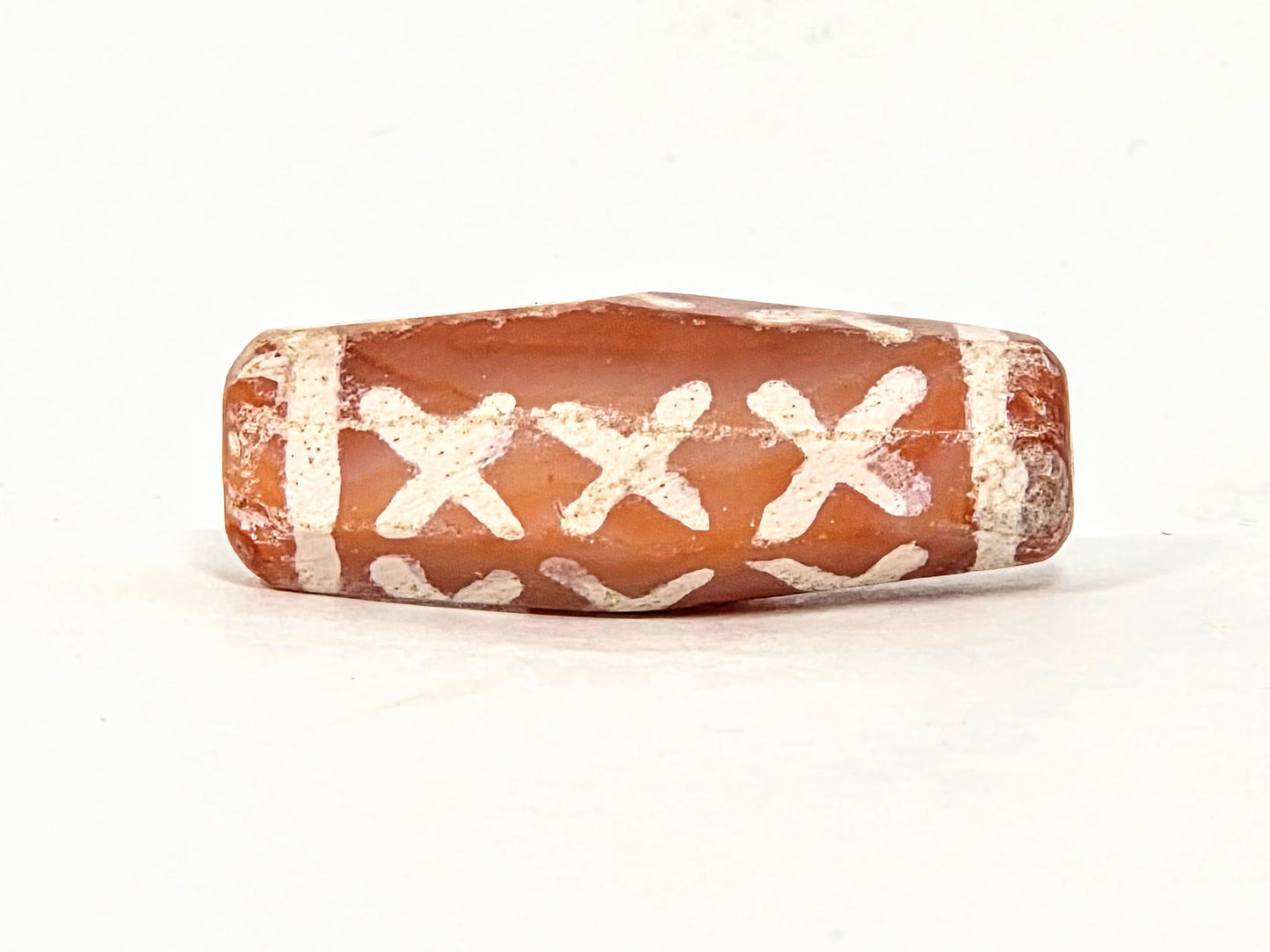 Ac-062426-12X ancient twelve X-cross carnelian dzi 28.5x11.0mm third face worn right end cap disclosed unretouched