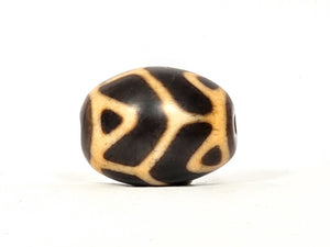 Antique Tibetan Round Dzi Bead featuring the Tiger Tooth Longevity Motif (110525)