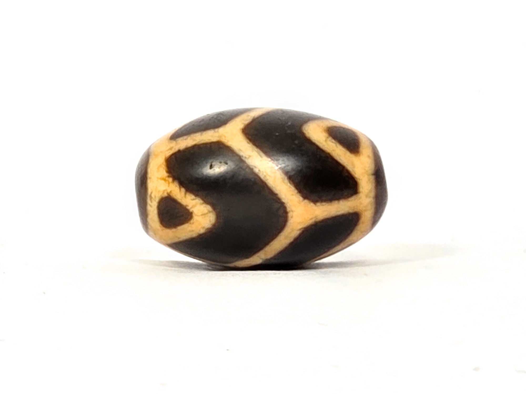 Antique Tibetan Round Dzi Bead featuring the Tiger Tooth Longevity Motif (110525)