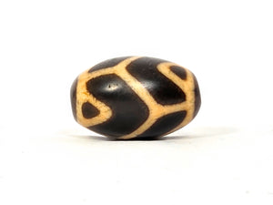 Antique Tibetan Round Dzi Bead featuring the Tiger Tooth Longevity Motif (110525)