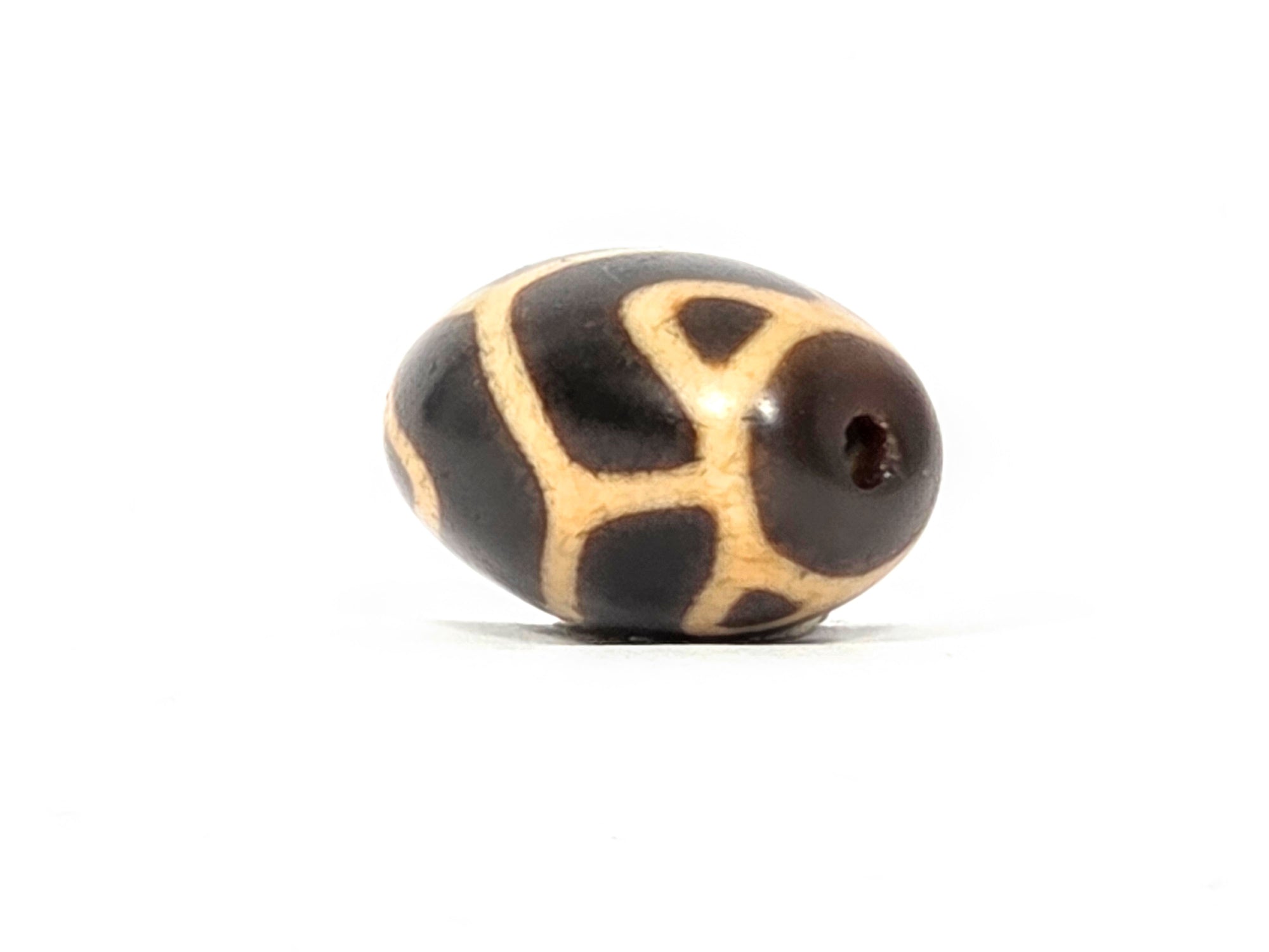 Antique Tibetan Round Dzi Bead featuring the Tiger Tooth Longevity Motif (110525)