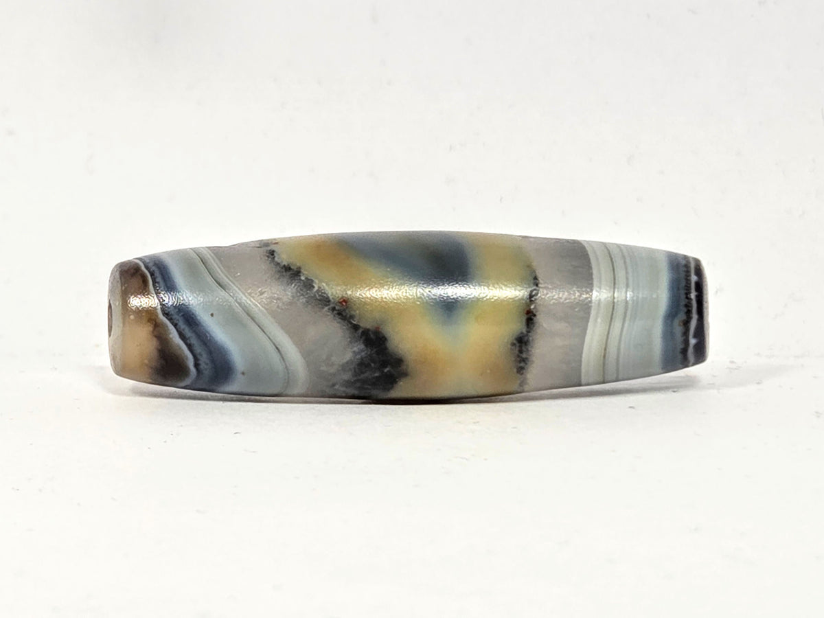 Antique agate dzi bead, natural one-eye motif, grey-blue banding, cream tones, visible drill hole, aged patina surface.