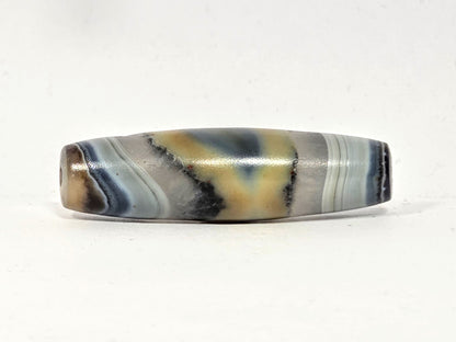 Antique agate dzi bead, natural one-eye motif, grey-blue banding, cream tones, visible drill hole, aged patina surface.