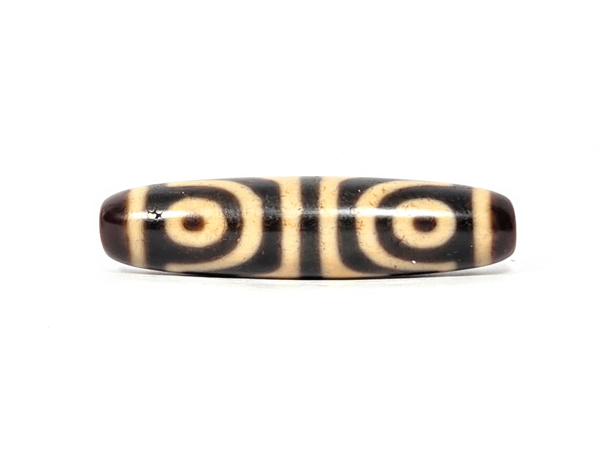 Second eye face of antique Four Eye Tiger Tooth dzi bead showing two concentric-ring eyes, cream agate, At-082525-4ETT
