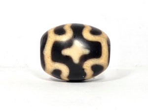 Black and beige bead with six eye lotus and cross pattern on agate