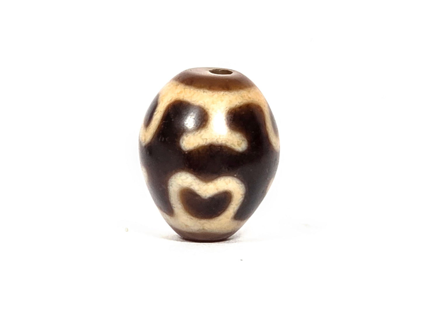 At-080926-4ELT antique round dzi bead 19.9×16.6mm, rotation A showing two upper eye forms and lower lotus arch on warm dark brown ground, drill hole visible top, unretouched