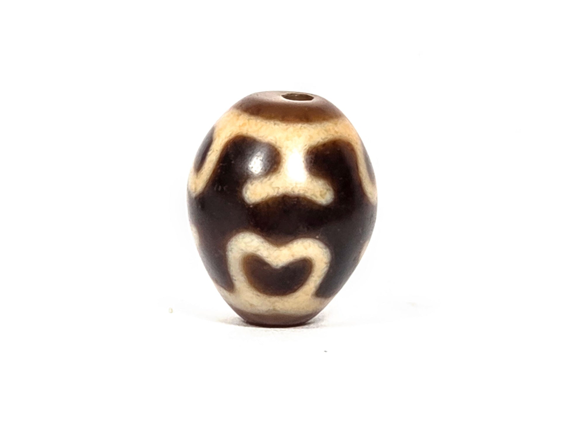 At-080926-4ELT antique round dzi bead 19.9×16.6mm, rotation A showing two upper eye forms and lower lotus arch on warm dark brown ground, drill hole visible top, unretouched