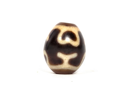 At-080926-4ELT antique round dzi bead 19.9×16.6mm, rotation D showing scroll-form upper element and curved treasure vase arms below, unretouched