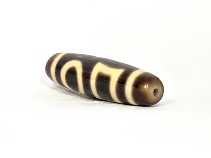 At-090425-DHE antique double heaven earth dzi drill end view one warm honey-brown tip agate unretouched