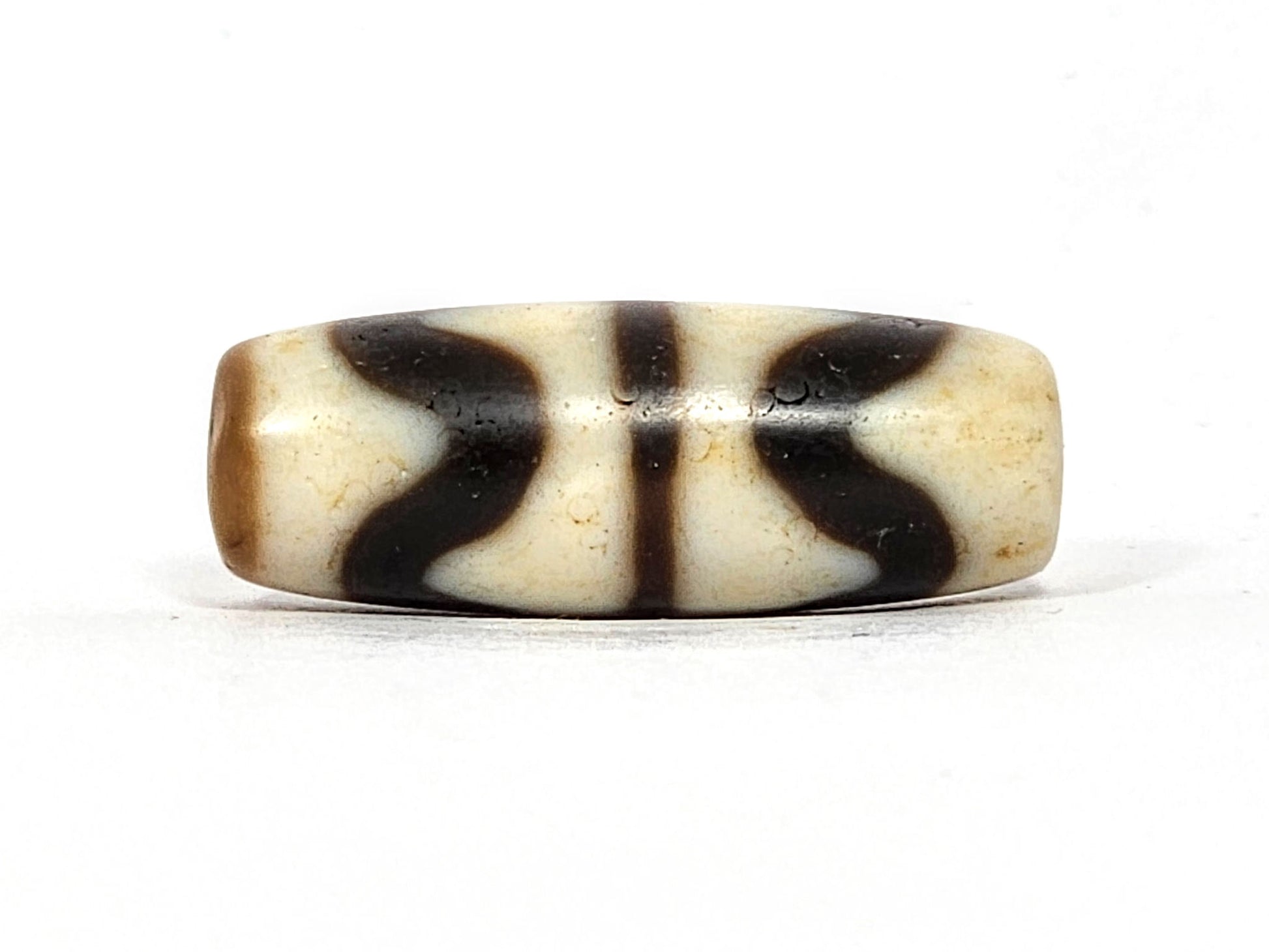 Third angle of antique Double Wave dzi At-072325-DW5, interlocking wave forms on warm brown natural agate, most compact double wave in collection, unretouched photography