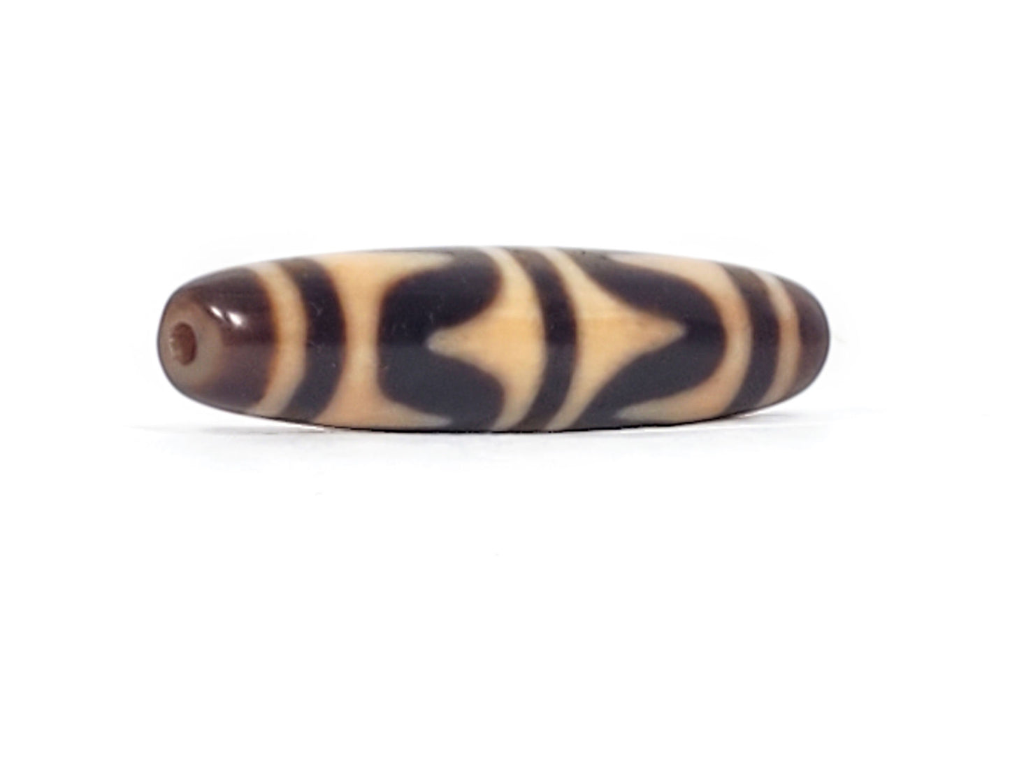 Angled view of antique Double Wave dzi bead end showing drill hole in warm brown agate cap, At-052526-DW4