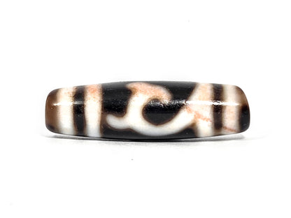 At-080426-GTBS antique Green Tara dzi bead 37.9×11.0mm, Face A showing flowing scroll motif on pitch-black ground, unretouched