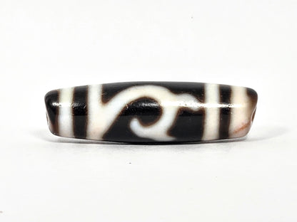 At-080426-GTBS antique Green Tara dzi bead 37.9×11.0mm, turn view showing scroll motif continuing around shoulder, cream-peach bloodspot zones, unretouched
