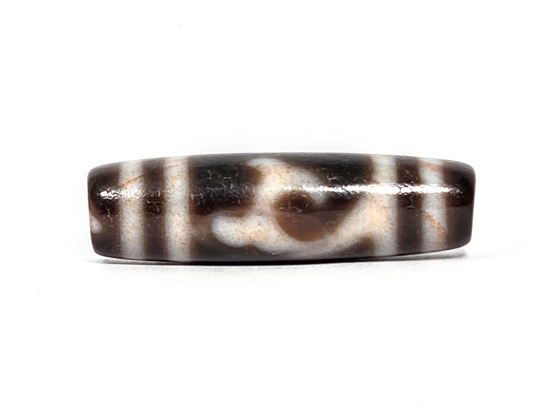 At-080426-GTBS2 antique Green Tara dzi bead 37.8×10.8mm, Face A showing scroll motif on very dark brown ground, cream lines with peach bloodspot tinge, unretouched
