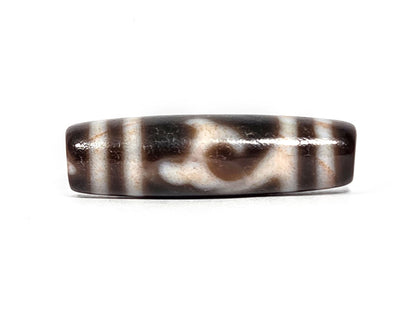 At-080426-GTBS2 antique Green Tara dzi bead 37.8×10.8mm, Face A showing scroll motif on very dark brown ground, cream lines with peach bloodspot tinge, unretouched
