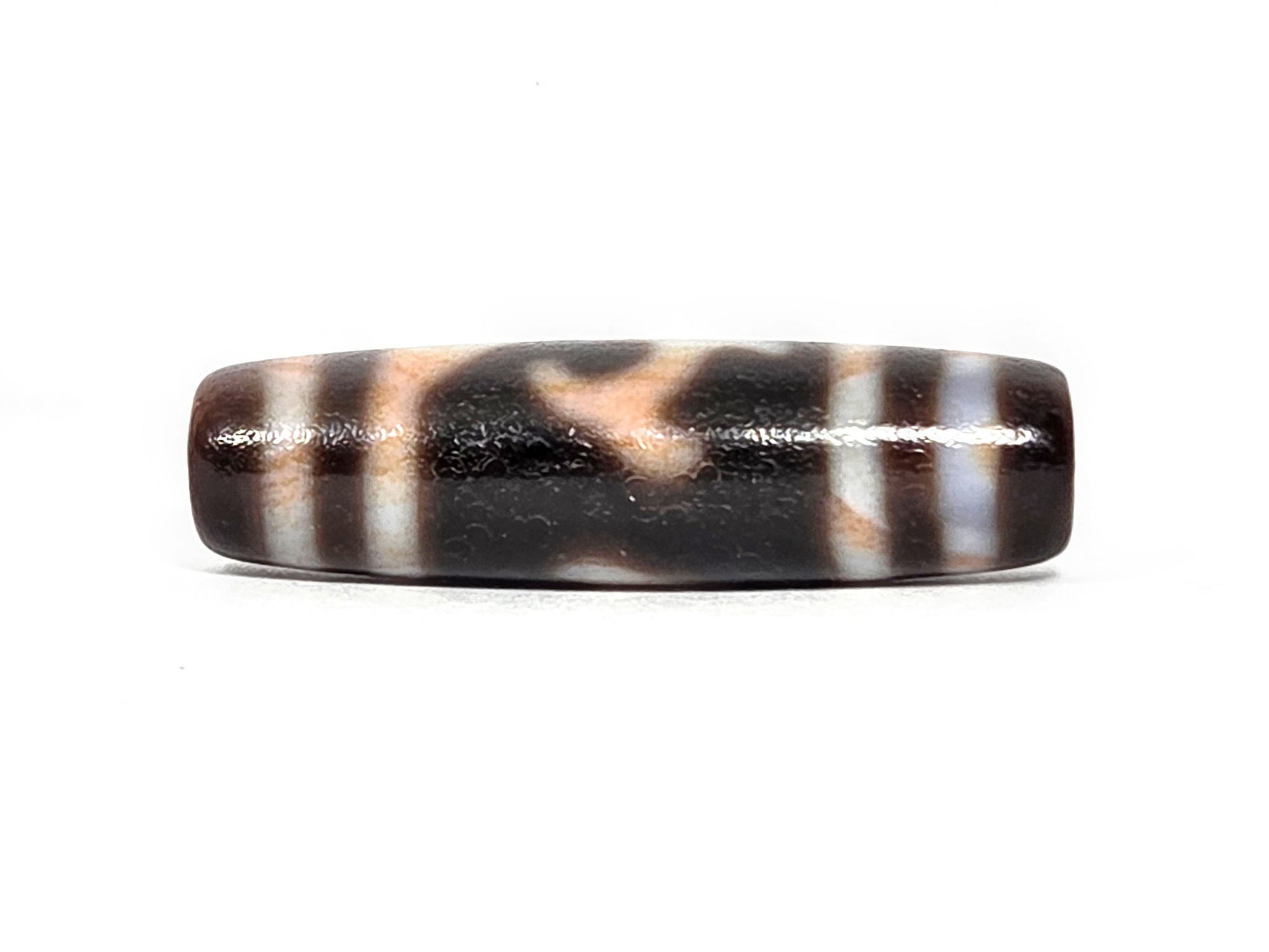 At-080426-GTBS2 antique Green Tara dzi bead 37.8×10.8mm, turn view opposite showing wave form and bloodspot-tinted cream zones in warm light, unretouched